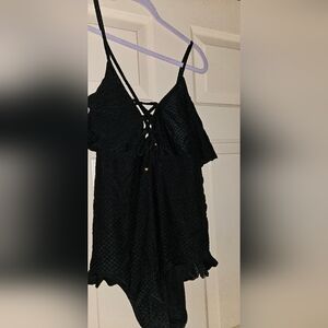 Size Large 1 pc swimsuit. Criss cross back and ruffle hip.